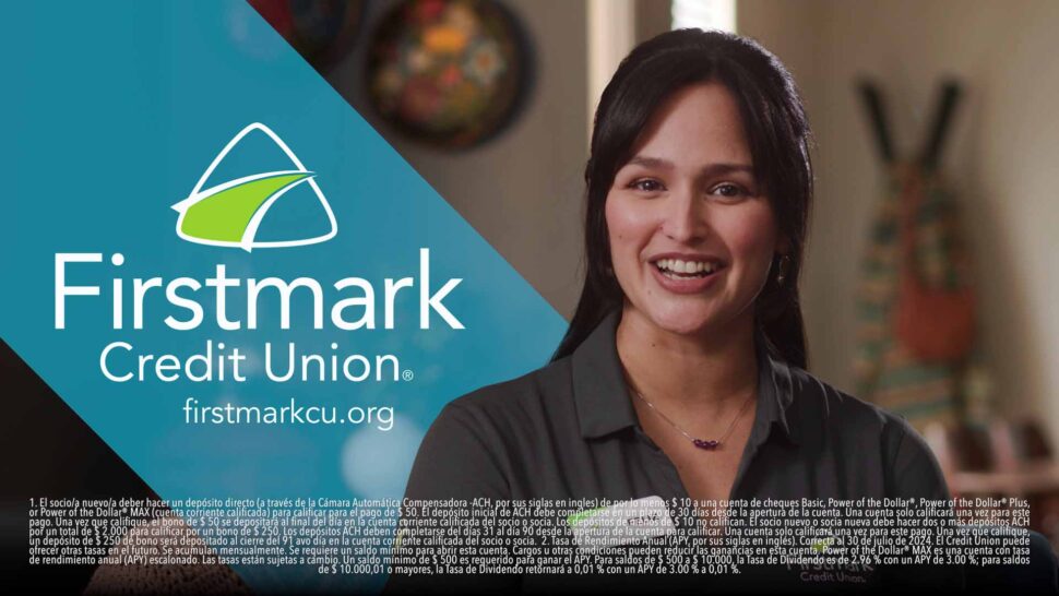 A woman smiling in an advertisment for Firstmark Credit Union